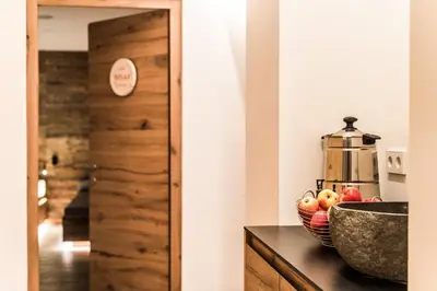a kitchen with a bowl of fruit on a counter at Hotel Regglbergerhof in Nova Ponente