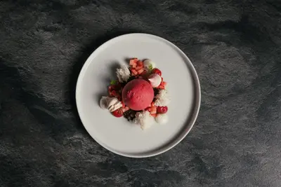 a white plate of food on a table at Hotel WH - Wiesnerhof in Vipiteno