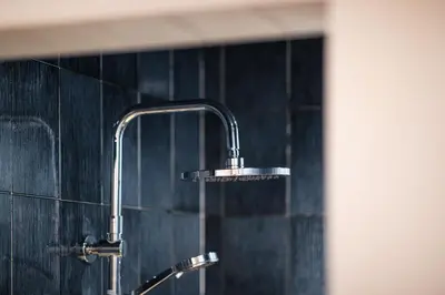 a shower with a faucet in a bathroom at Hotel Mühlwald in Selva dei Molini
