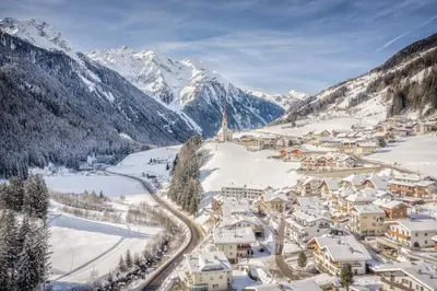 a small town in a valley with mountains at Hotel Mühlwald in Selva dei Molini