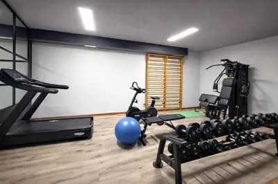 a gym with exercise equipment in a room at Hotel Rododendro Val di Fassa in Campitello di Fassa