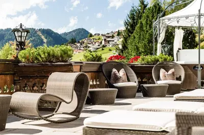 a patio with chairs and a gazebo at Romantik & Family Hotel Gardenia***S in Selva di Val Gardena