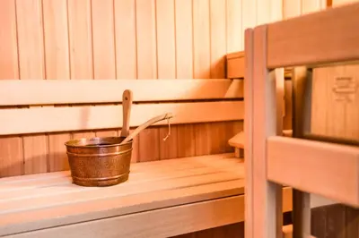 a bucket sitting on a shelf in a sauna at Romantik & Family Hotel Gardenia***S in Selva di Val Gardena