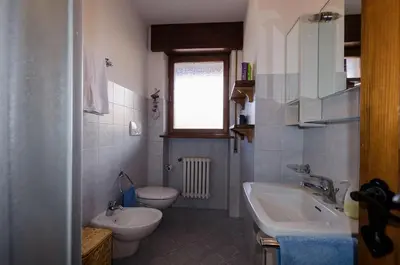 a bathroom with a sink and a toilet and a sink at Overlooking the Dolomites in Cortina dʼAmpezzo