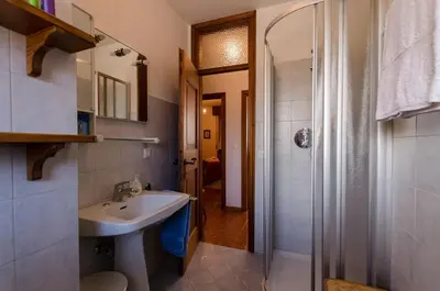 a bathroom with a sink and a shower at Overlooking the Dolomites in Cortina dʼAmpezzo
