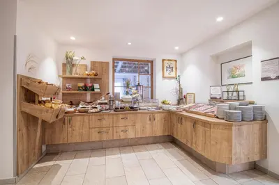 a kitchen with a counter with dishes on it at Alpin Hotel Gudrun in Colle Isarco