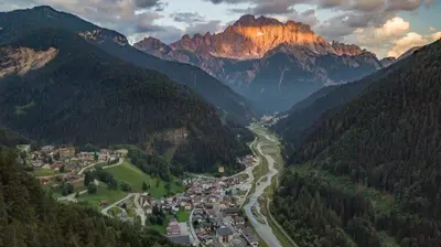a town in a valley with mountains in the background at Hotel Alla Posta - Famiglia Pra dal 1866 a Caprile in Alleghe