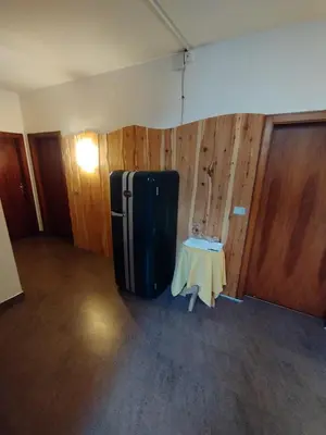 a room with a black refrigerator and a table at Garni Weingut in Merano