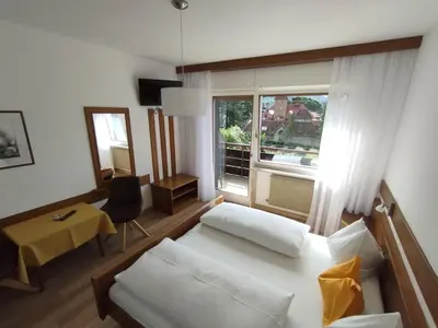 a living room with a white couch and a window at Garni Weingut in Merano