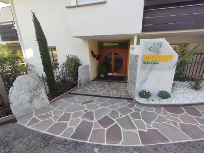 a building with a sign in front of it at Garni Weingut in Merano