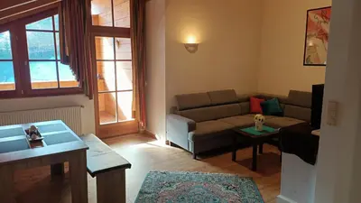 a living room with a couch and a table at Haus Traudi in Nova Ponente