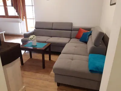 a living room with a couch and a table at Haus Traudi in Nova Ponente
