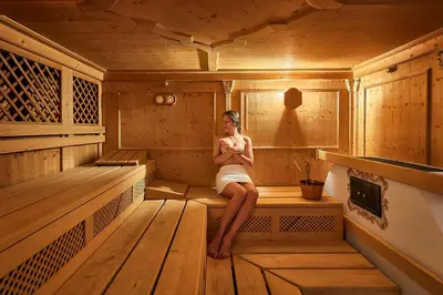 a woman sitting in the inside of a sauna at Mountain Hotel Mezdì in Colfosco