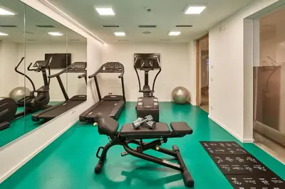 a gym with treadmills and elliptical machines at Mountain Hotel Mezdì in Colfosco
