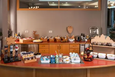 a kitchen with a counter with food on it at Hotel Brenner - Stop & Go in Vipiteno