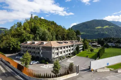 an aerial view of a building with a parking lot at Hotel Brenner - Stop & Go in Vipiteno