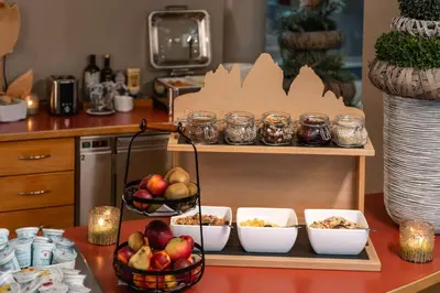 a counter with bowls of food on a shelf at Hotel Brenner - Stop & Go in Vipiteno