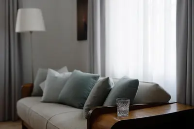 a living room with a couch and a glass on a table at 1477 Reichhalter, a Member of Design Hotels in Lana