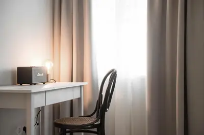a chair next to a desk with a computer on it at 1477 Reichhalter, a Member of Design Hotels in Lana