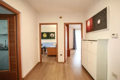 a kitchen and a living room with a table at Ferienwohnungen grazia dei in Lagundo