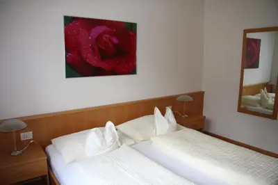 two beds in a bedroom with a painting on the wall at Ferienwohnungen grazia dei in Lagundo