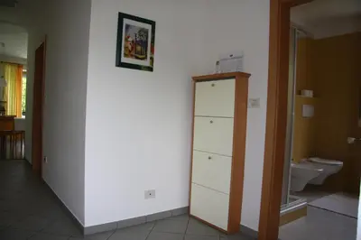 a bathroom with a toilet and a cabinet at Ferienwohnungen grazia dei in Lagundo