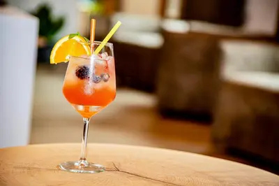 a drink sitting on top of a wooden table at Chalet Aster in Moena