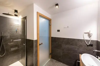 a bathroom with a shower and a sink at Chalet Aster in Moena