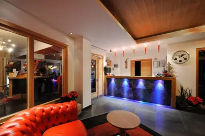a living room with a couch and a fish tank at Sport Hotel S. Vigilio in Moena