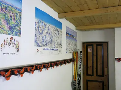 a room with a wall with posters and skis at Digonera Historic Hotel B&B in Rocca Pietore