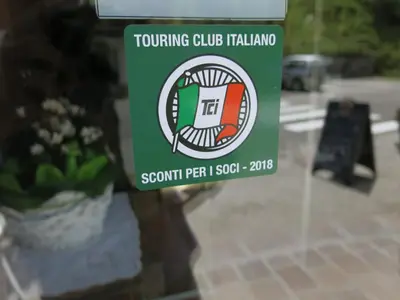 a sign on a window of a building at Digonera Historic Hotel B&B in Rocca Pietore