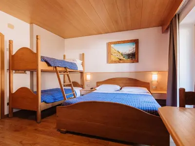 a bedroom with two bunk beds and a table at Apartment Garni Eden by Interhome in Soraga
