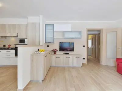 a kitchen and living room with a table and chairs at Apartment Bernard-3 by Interhome in Campestrin