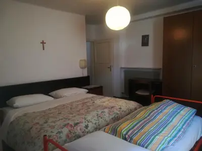 a hotel room with a bed and a lamp at Hotel Roen Ruffrè-Mendola in Mendola
