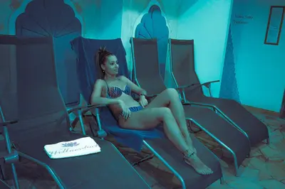 a woman sitting in a seat on an airplane at Hotel Alba Wellness & Spa in Canazei