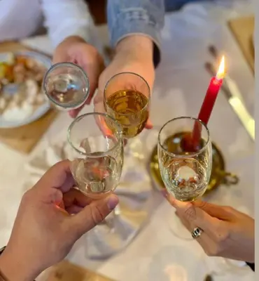 a group of people holding wine glasses on a table at Hotel Alba Wellness & Spa in Canazei
