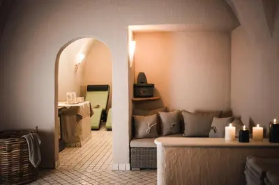 a room with a couch and a table with candles at Hotel Cavallino D'Oro Bed&Breakfast in Castelrotto