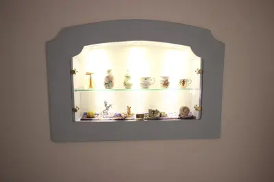 a mirror hanging on a wall with vases on it at Hotel Rosalpina in Soraga