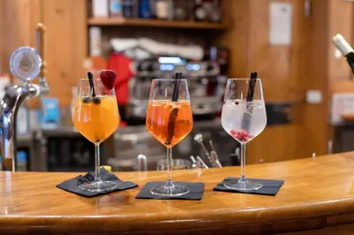 three wine glasses sitting on top of a counter at Hotel Fanes Suite & Spa in Moena
