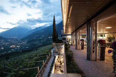 a house with a view of a mountain at SPA & Relax Hotel Erika in Tirolo