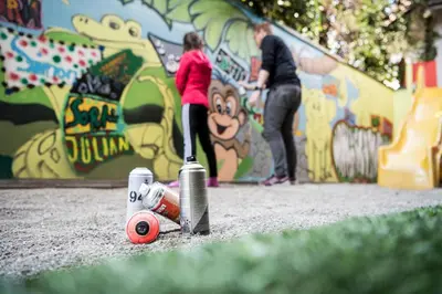 a little girl is playing on a t ball in a park at SPA & Relax Hotel Erika in Tirolo