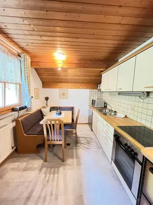 a kitchen with a table and a dining room at Schwaningerhof in Cermes