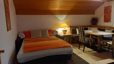 a bedroom with a bed and a dining room at Schwaningerhof in Cermes