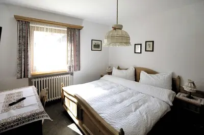 a bedroom with a large bed and a window at Villa Ula Verda- Apartments Marianna in Santa Cristina in Val Gardena