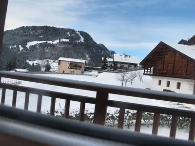 a view of a snow covered mountain from a balcony at Villa Ula Verda- Apartments Marianna in Santa Cristina in Val Gardena