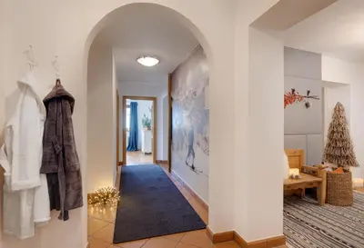a hallway with an archway in a house at Chaletapartement Ambiente Villa Mozart mit Sauna in Chienes