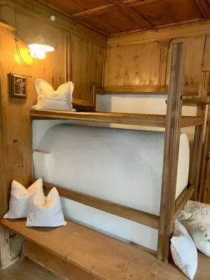 a bedroom with two bunk beds in a cabin at Chaletapartement Ambiente Villa Mozart mit Sauna in Chienes