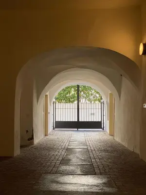 a hallway with an archway with a gate in a building at Life Apartment & City Bike in Bolzano