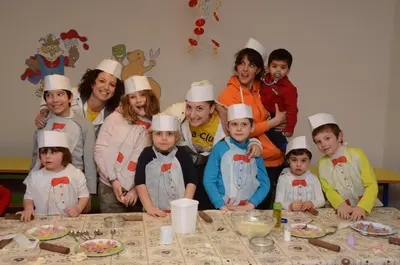 a group of children wearing chefs hats posing for a picture at Resort Dolce Casa - Family & Spa Hotel in Moena