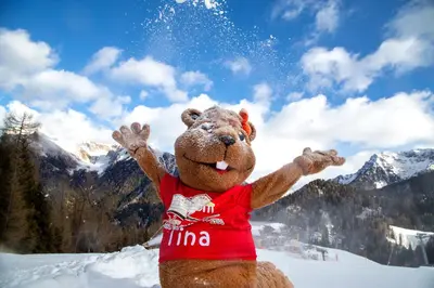 a teddy bear is standing in the snow at Resort Dolce Casa - Family & Spa Hotel in Moena